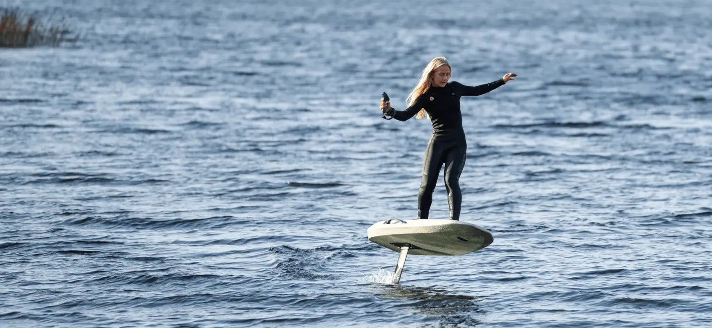 Rider flying on a Waydoo e-foil over open ocean